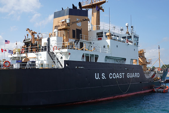 Many coast guard ships were docked at the coast guard station.