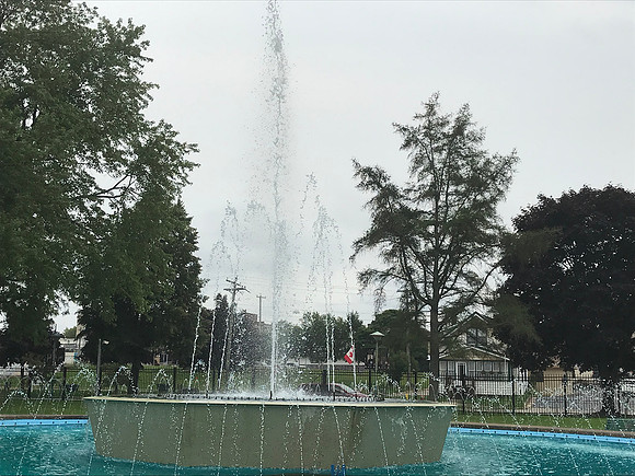 The fountain in the park located in the large secured viewing area.