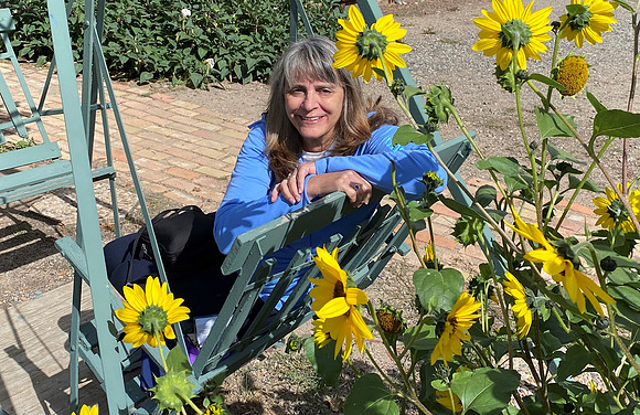 Terri enjoyed relaxing amid the sunflowers.