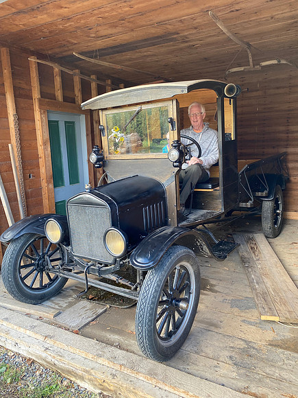 Denny got to sit in an antique car they had in the barn.