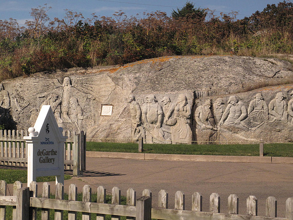 Wm. deGarthe carved a granite mural into monument to Nova Scotian fishermen.  It depicts 32 fishermen, their wives, and children enveloped by the wings of a guardian angel.